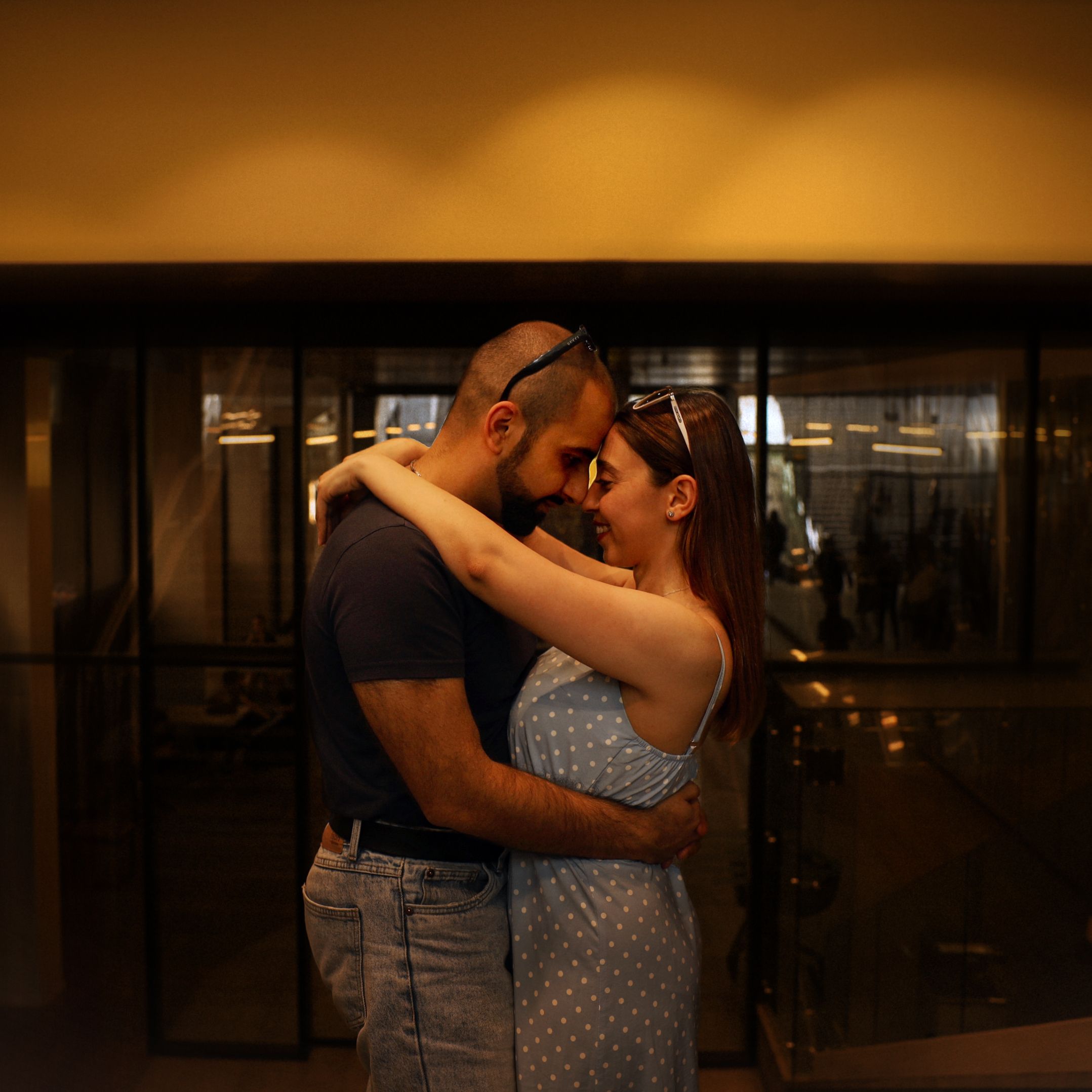 A couple shares an intimate embrace indoors in Armenia, capturing a moment of love and connection.